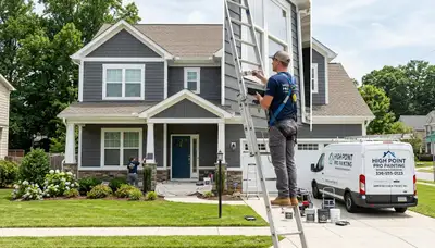 Professional house painters finishing exterior home in Greensboro NC